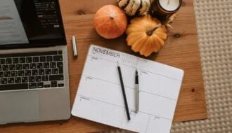 pumpkins and a planner on wooden desk