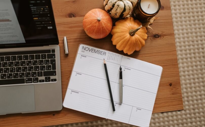 pumpkins and a planner on wooden desk